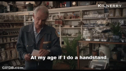A Man In A Store With The Words At My Age If I Do A Handstand Above Him GIF