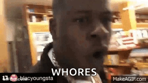 A Man In A Store With The Words Whores On The Bottom Right GIF