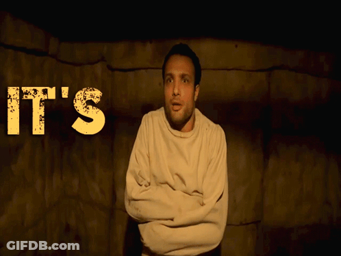 A Man In A Straight Jacket Stands In Front Of A Sign That Says It 'S F ** King GIF