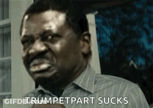 A Man In A Striped Shirt And Tie Is Making A Funny Face And Says Trumpetpart Sucks . GIF