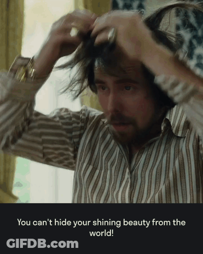 A Man In A Striped Shirt Is Adjusting His Hair With A Caption That Says You Can 'T GIF