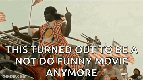 A Man In A Striped Shirt Is Giving The Middle Finger In Front Of A Crowd . GIF