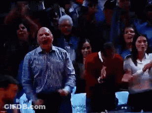 A Man In A Striped Shirt Is Screaming In A Crowd Of People While Holding A Sign That Says Award Able GIF