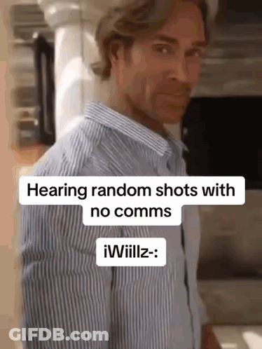 A Man In A Striped Shirt Is Standing In Front Of A Sign That Says Hearing Random Shots With No Comms . GIF