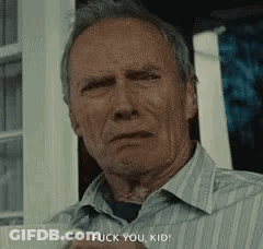 A Man In A Striped Shirt Is Standing In Front Of A Window And Says `` Fuck You Kid '' . GIF