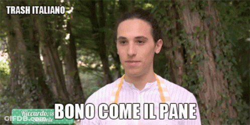 A Man In A Striped Shirt Is Standing In Front Of Trees And Says Bono Come Il Pane GIF