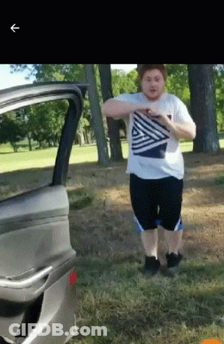 A Man In A Striped Shirt Is Standing Next To A Car Door GIF
