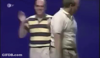 A Man In A Striped Shirt Is Standing Next To A Man In A White Shirt GIF