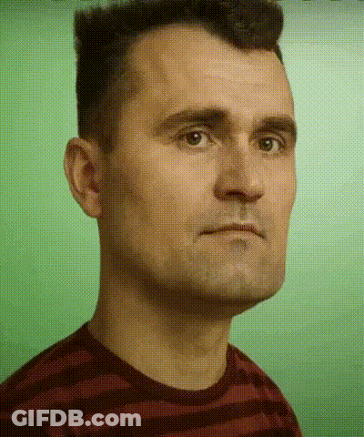 A Man In A Striped Shirt Looks At The Camera With A Green Background GIF