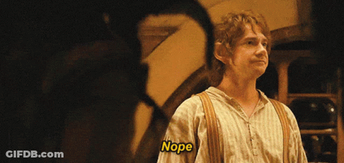 A Man In A Striped Shirt Says Nope In A Dark Room GIF