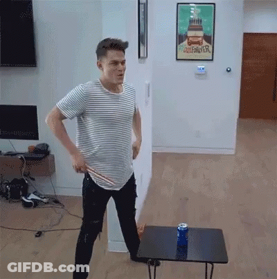 A Man In A Striped Shirt Stands In Front Of A Poster That Says California GIF