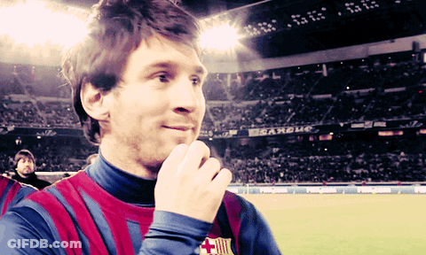 A Man In A Striped Shirt Stands In Front Of A Sign That Says ' Estadio ' On It GIF