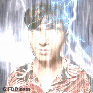A Man In A Striped Shirt Stands In The Rain With Lightning Behind Him GIF