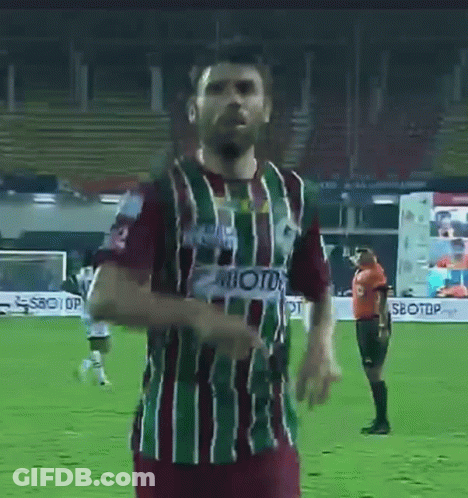 A Man In A Striped Shirt With The Number 3 On It Is Standing On A Soccer Field . GIF