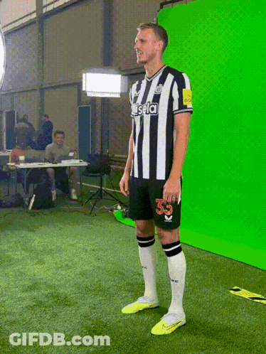 A Man In A Striped Shirt With The Number 33 On It GIF