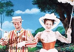 A Man In A Striped Suit And A Woman In A White Dress Are Standing Next To Each Other GIF