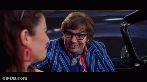 A Man In A Striped Suit And Tie Is Talking To A Woman In A Car And The Caption Says Oh Behave . GIF