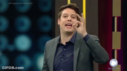 A Man In A Suit And A Blue Shirt Is On A Record Tv Show GIF