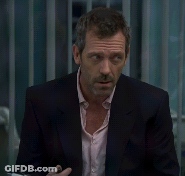 A Man In A Suit And A Pink Shirt Looks Serious GIF