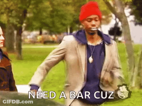 A Man In A Suit And A Red Hat Is Walking In A Park And Says Need A Bar Cuz GIF
