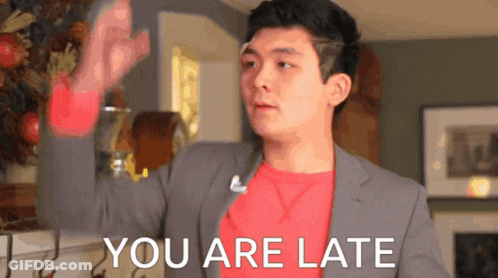 A Man In A Suit And A Red Shirt Says You Are Late GIF