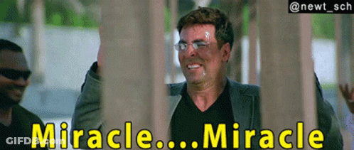 A Man In A Suit And Black Shirt Is Smiling With The Words " Miracle ... Miracle " Behind Him GIF
