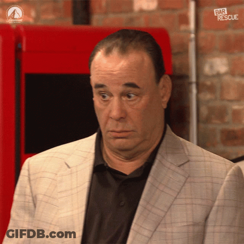 Man In Suit And Black Shirt In Front Of Bar Rescue Machine GIF