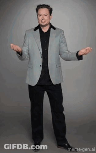 A Man In A Suit And Black Shirt Is Standing With His Arms Outstretched GIF