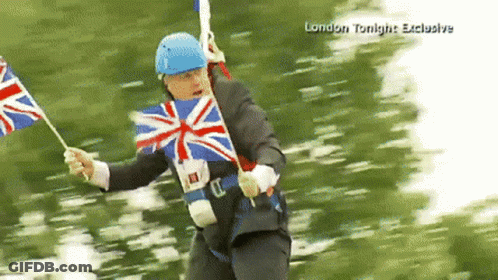 A Man In A Suit And Blue Helmet Is Holding A British Flag In A London Tonight Exclusive GIF