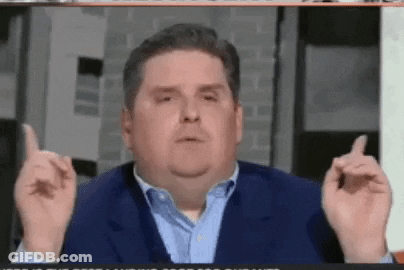 A Man In A Suit And Blue Shirt Is Giving The Middle Finger . GIF