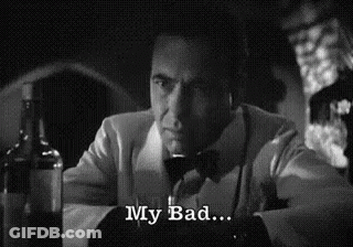 A Man In A Suit And Bow Tie Is Sitting At A Table With A Glass Of Wine And A Bottle Of Alcohol . GIF
