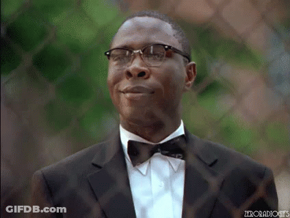 A Man In A Suit And Bow Tie Is Smiling And Looking Up . GIF