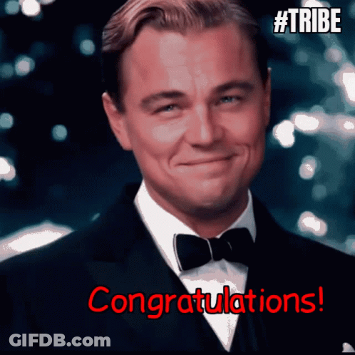 A Man In A Suit And Bow Tie Is Smiling With The Words Congratulations In Red GIF