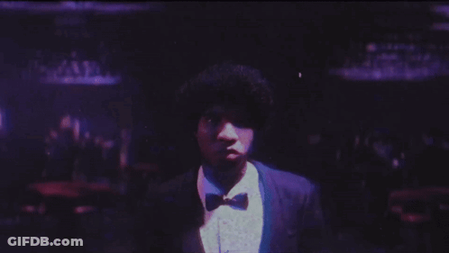 Man In Suit And Bow Tie In Front Of Purple Background GIF