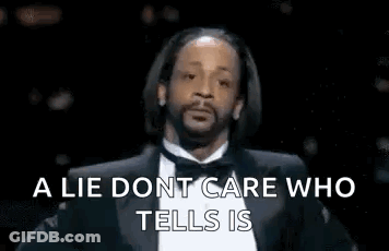 A Man In A Suit And Bow Tie Is Talking About A Lie Dont Care Who Tells Is . GIF