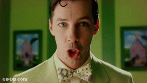 A Man In A Suit And Bow Tie Making A Surprised Face GIF
