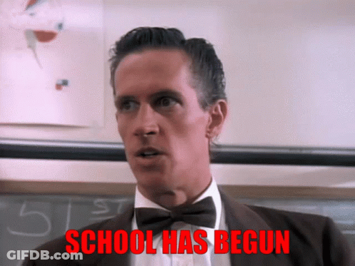A Man In A Suit And Bow Tie Says School Has Begun In Red GIF