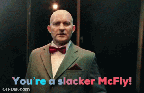 A Man In A Suit And Bow Tie With The Words You 'Re A Slacker Mcfly GIF