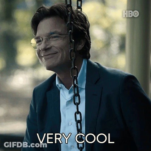 A Man In A Suit And Glasses Is Smiling While Sitting On A Swing With The Words " Very Cool " Below Him GIF