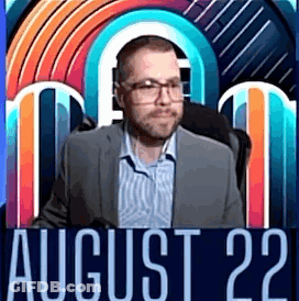 A Man In A Suit And Glasses Is Standing In Front Of A Colorful Background With The Date August 22 . GIF