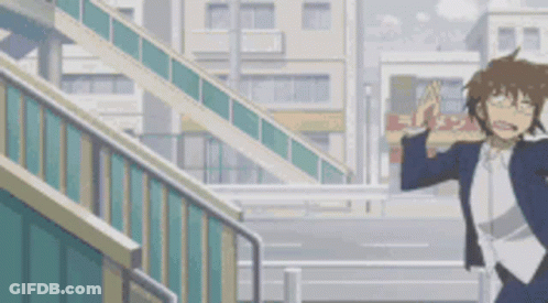 A Man In A Suit And Glasses Is Walking Down A Set Of Stairs . GIF