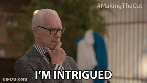 A Man In A Suit And Glasses Says I 'M Intrigued GIF