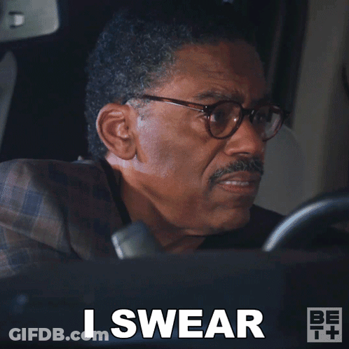 A Man In A Suit And Glasses Says I Swear While Driving A Car GIF