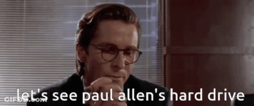 A Man In A Suit And Glasses Says " Let 'S See Paul Allen 'S Hard Drive " GIF