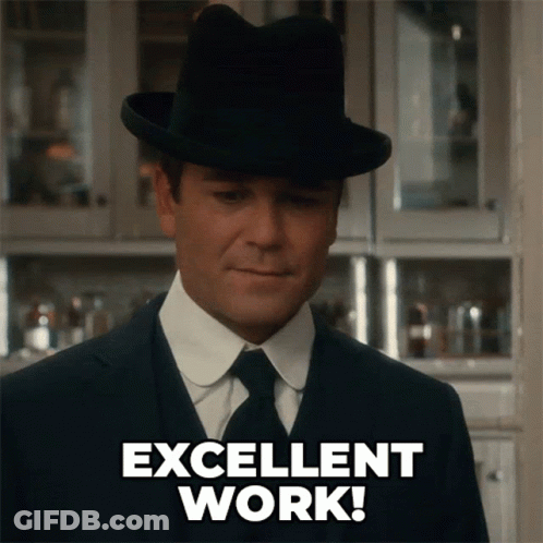 A Man In A Suit And Hat Is Giving An Excellent Work Sign GIF