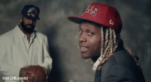 A Man In A Suit And Hat Is Holding A Basketball Next To Another Man In A Suit . GIF