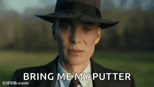 A Man In A Suit And Hat Is Standing In A Field With The Words `` Bring Me My Putter '' Written On The Screen . GIF
