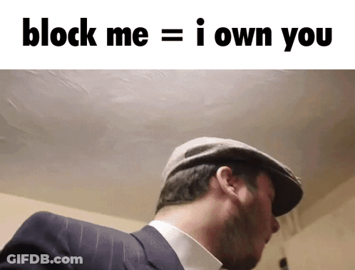 A Man In A Suit And Hat With The Words Block Me = I Own You Above Him GIF