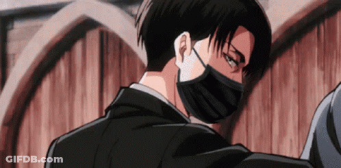 A Man In A Suit And Mask Is Standing Next To A Wooden Wall . GIF