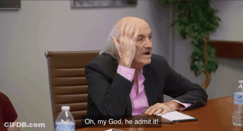A Man In A Suit And Pink Shirt Is Sitting At A Table And Says Oh My God He Admit It . GIF